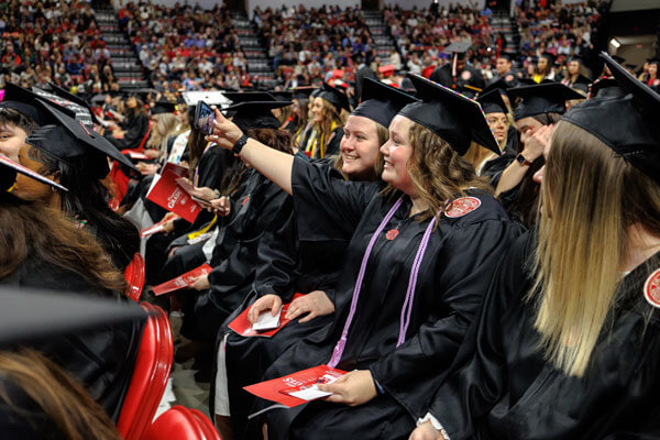 Graduates take a selfie during commencement.