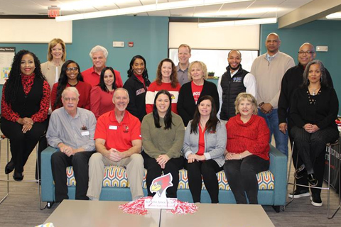 group of people in Redbird apparel smiling